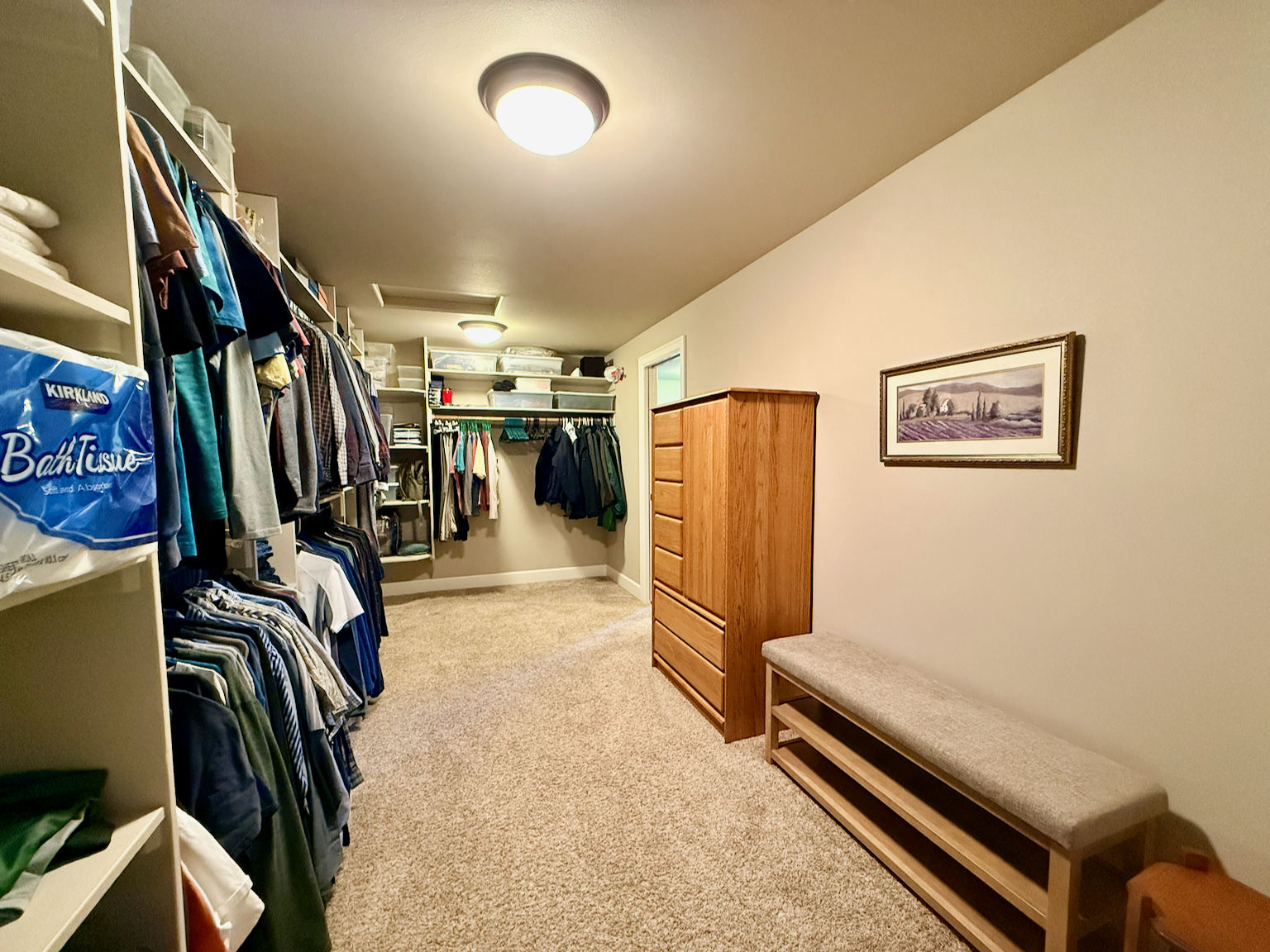 Primary closet with door to laundry room